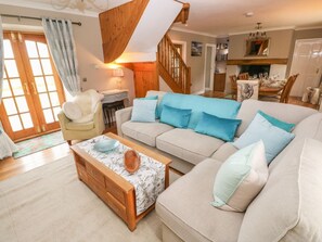 A living room with a sofa, a coffee table, and a wooden cabinet. - North Studdock Cottage, Pembroke (Pembroke)