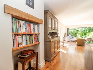 A room with a bookshelf, a cabinet, and a view of the outdoors. - Hathaway Lane in Warwickshire. (Stratford-upon-Avon)