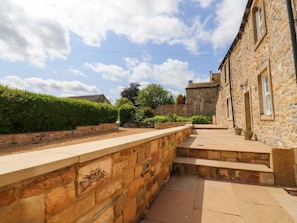 A stone building with a stone pathway leading to a set of steps. - Rowan Tree Cottage, Skipton (Skipton)