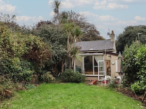 A house with a glass door, surrounded by dense vegetation. - Teign Place, Teignmouth (Teignmouth)