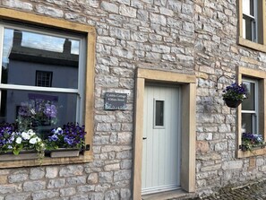 A stone building with a sign reading 'Cobble Cottage 4 Main Street.' - Cobble Cottage, Gisburn (Clitheroe)