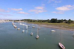 A marina with multiple sailboats docked.
