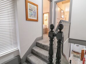 A staircase with a wooden handrail and a carpeted landing. - The Corner House, Londonderry, Northern Ireland (Londonderry)