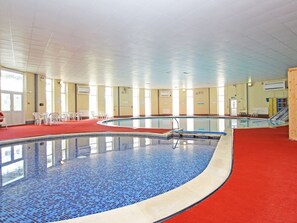 An indoor swimming pool with a red carpet, tiled walls, and a clear ceiling. - Dartmoor Valley Lodge, Gunnislake (Callington)