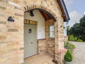 A stone building with a door, a window, and a small garden area. - Fern Cottage, Elsworth, Cambridge (Cambridge)
