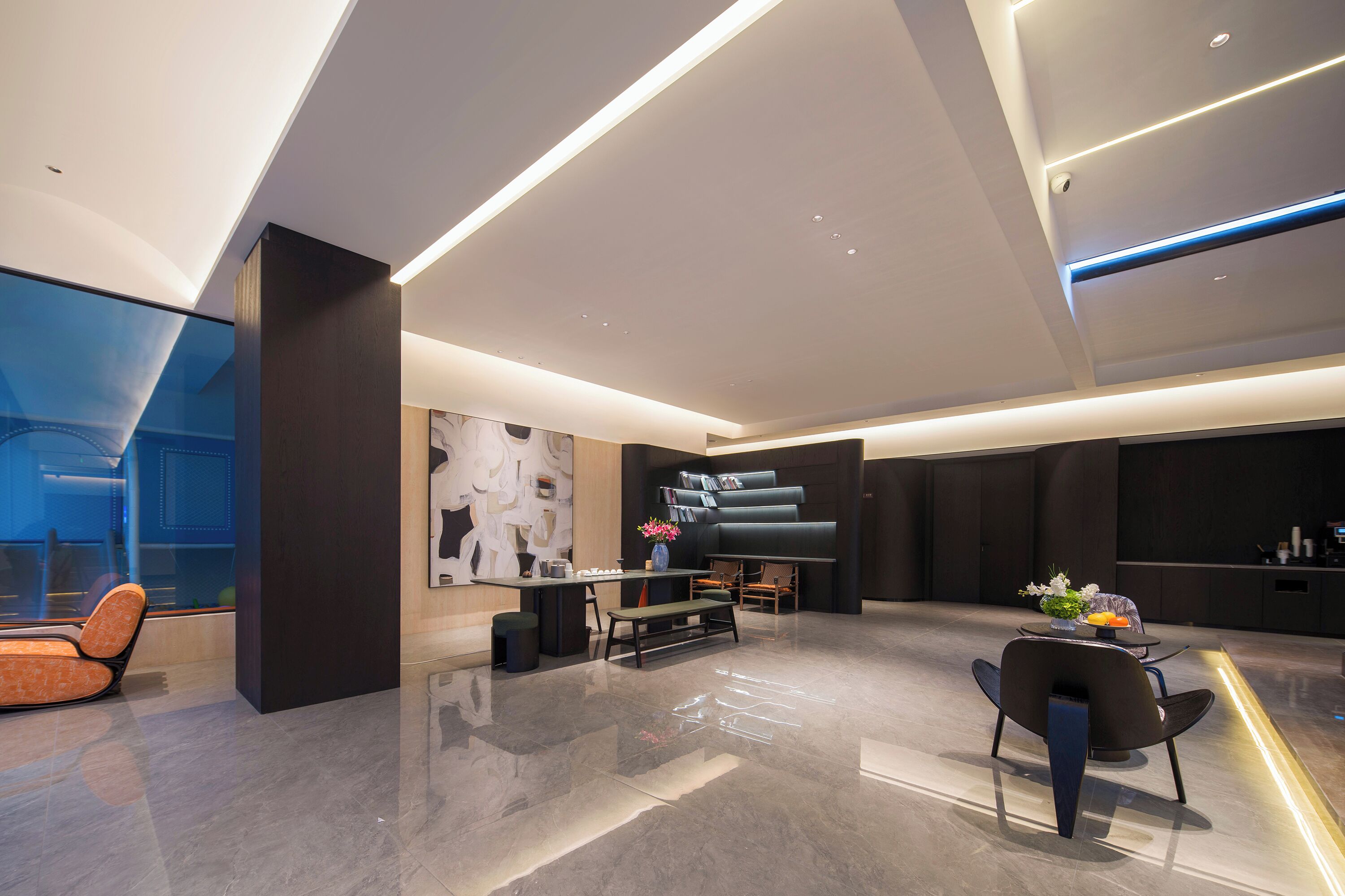 A modern interior with a seating area, a piano, and a large abstract artwork on the wall.