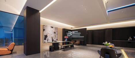 A modern interior with a seating area, a piano, and a large abstract artwork on the wall.