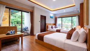 A hotel room with a large bed, a smaller bed, a desk, and a chair. - Hotel HTC Thimphu (Thimphu)