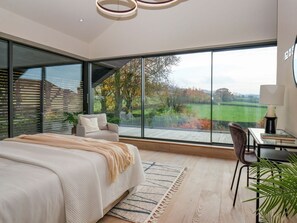 A modern bedroom with a large window, a bed, a desk, and a chair. - Woldside, Bishop Wilton (York)