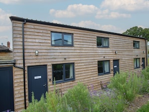 A two-story wooden building with multiple windows and doors, including a sign that reads 'ASCOT.' - Ascot, Overton near Ellesmere. (Wrexham)