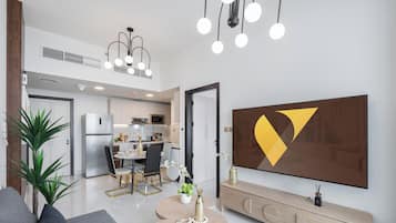 Deluxe Apartment | Living area | 65-inch Smart TV with cable channels