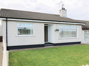 A single-story house with a tiled roof, a front door, and a small front yard. - Hazel Cottage, Portrush (Portrush)