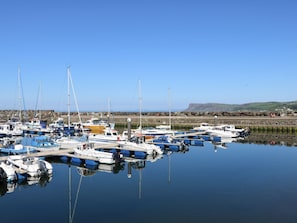 A marina with multiple boats docked, calm water, and a clear sky. - Hazel Cottage, Portrush (Portrush)