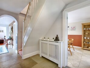 A staircase with a white railing, a white radiator, and a wooden chair. - Ingleside: Charming Home in Adsett (Westbury-on-Severn)