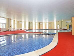 An indoor swimming pool with a tiled floor, a red carpeted area, and a staircase leading to an upper level. - Manorcombe 40, near Drakewalls (Callington)