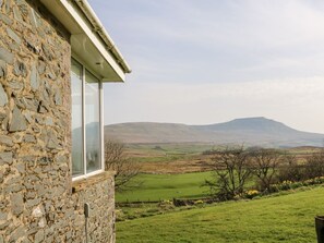 A stone building with a large window, a grassy field, and distant hills. - Netherscar, Ingleton (Carnforth)