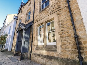 A stone building with a window, a door, and a small step leading to the entrance. - 26 Frenchgate, Richmond (Gateway)