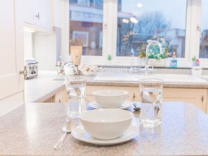A kitchen counter with two white bowls, two glasses of water, and a spoon. - Lakeland View, Keswick Cumbria (Keswick)