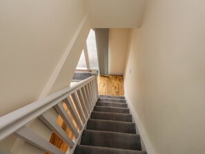 A staircase with white railings leading to a wooden floor. - Bryn Mair, Llangefni (Llangefni)