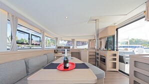 A modern interior with a dining area, seating, and a kitchen.