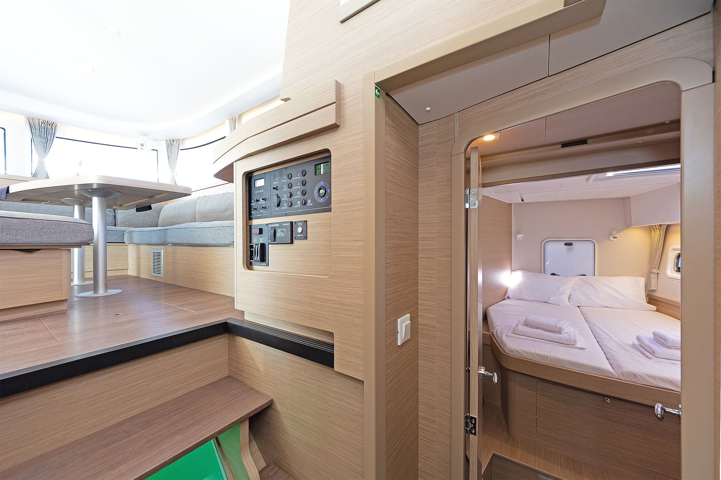 A compact, modern interior with a kitchenette, a seating area, and a sleeping berth.