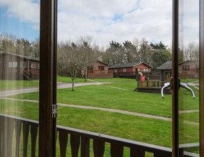 A view of a residential area with houses, a playground, and a clear sky.