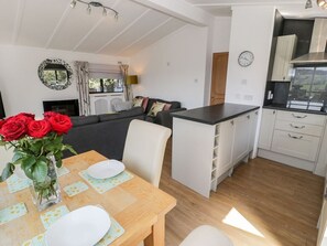 A compact living space with a dining area, kitchen, and seating area.