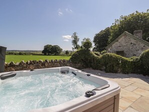 A hot tub with a clear view of the countryside.