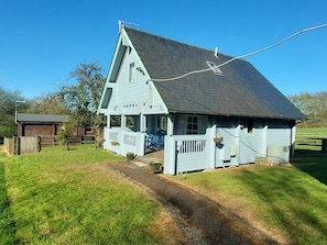 A single-story house with a gabled roof, a front porch, and a small front yard. - Orchard Lodge, Sampford Peverell, Devon (Wellington)