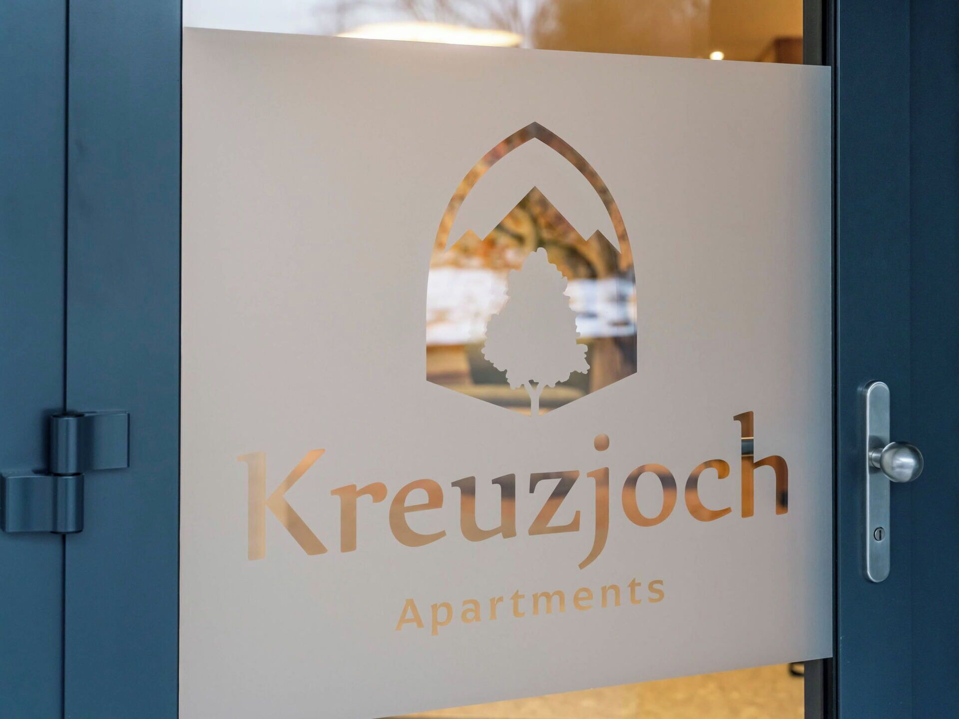 A door with a logo and text for Kreuzjoch Apartments.