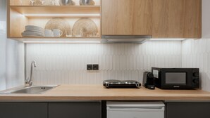 A modern kitchen with a dishwasher, microwave, and a coffee maker on the counter. - LIV - Comfortable Athens Studio S8-2C (Athens)