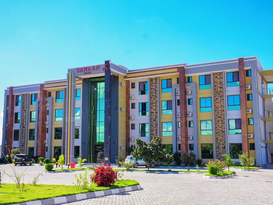 A multi-story hotel with a modern facade, large windows, and a central entrance.