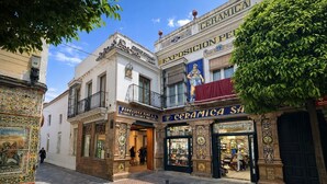 A street with buildings, including a shop with a sign that reads 'CERAMICA S.A.' - Premium, elegant, and exclusive apartment in Triana & Sleeps 4 & Private patio (Sevilla)