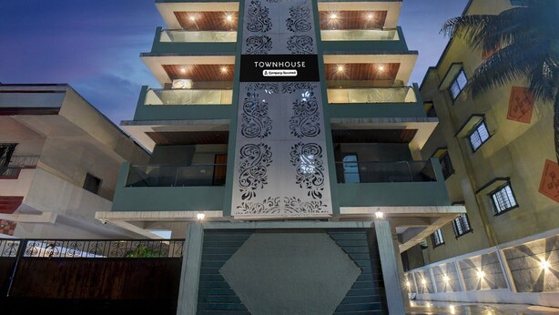 A multi-story building with a central vertical sign reading 'TOWNHOUSE.' - Deluxe Townhouse Pimple Nilakh Pune (Pune)