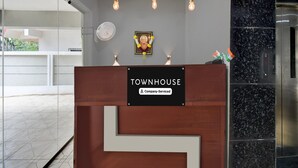 A reception desk labeled 'TOWNHOUSE' with a sign indicating 'Company-Serviced.' - Deluxe Townhouse Pimple Nilakh Pune (Pune)