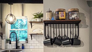 A kitchen with a countertop, a coffee maker, a toaster, a hanging rack with pots, and a window with a view. - New! Pet Friendly Lake Nockamixon Cottage Hideaway (Quakertown)