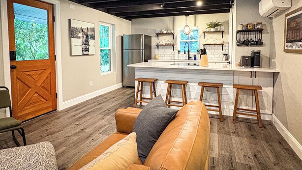 A modern kitchen with a central island, bar stools, and a wooden ceiling. - New! Pet Friendly Lake Nockamixon Cottage Hideaway (Quakertown)