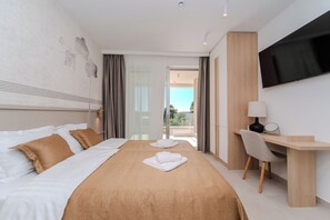 A hotel room with a bed, a desk, a TV, and a view of the outdoors. - Villa Nexi by old Town (Sibenik)