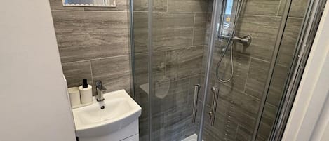 Shower, hair dryer, towels, toilet paper