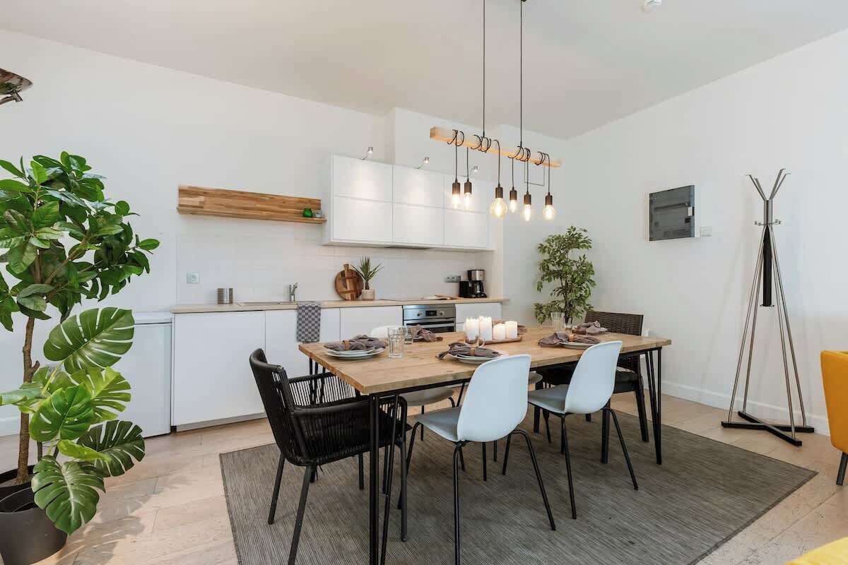 Open kitchen — elegant white design with natural accents.
