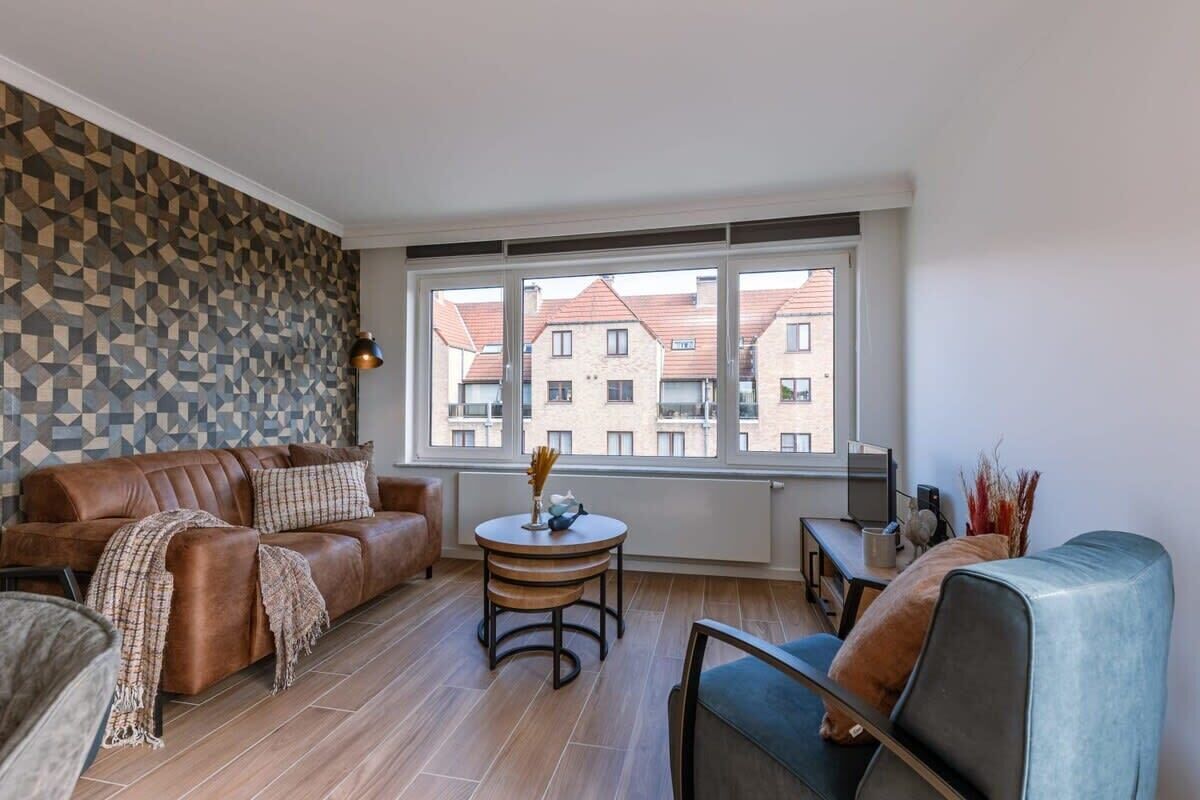 Warm living room with textured accent wall and soft natural light.
