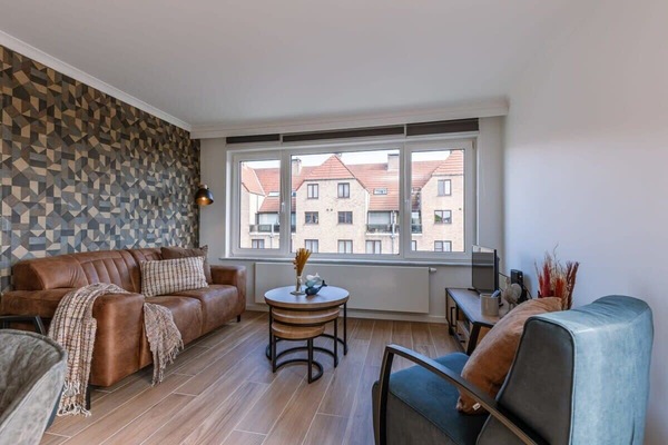Warm living room with textured accent wall and soft natural light.