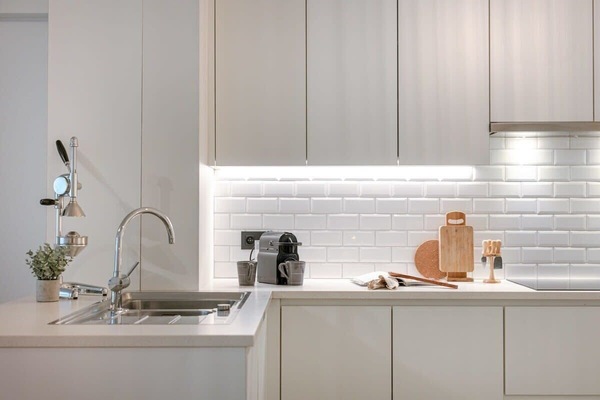 Modern kitchen with white cabinetry and under-cabinet lighting