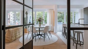 A modern interior with a dining area, kitchen, and seating space. - Family-ready apt w/ game console - heart of Ostend (Oostende)
