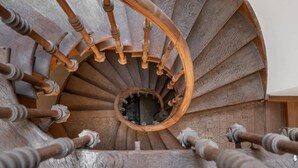 Una escalera de caracol con escalones de madera y un agujero central.