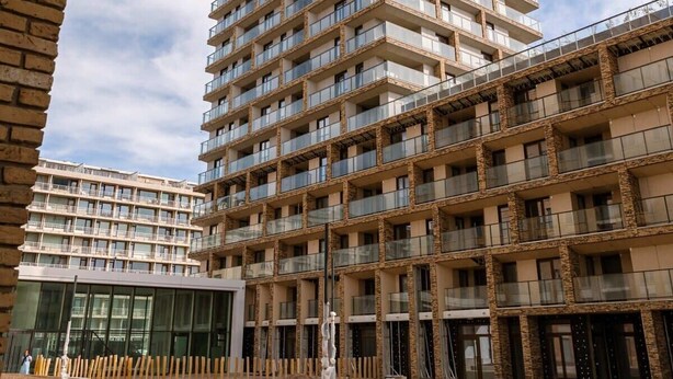 A multi-story residential building with balconies, a central courtyard, and a modern architectural style. - Coastal retreat w/ terrace & self check-in (Oostende)