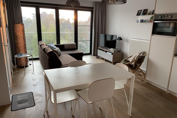Bright living area with dining space and river view.