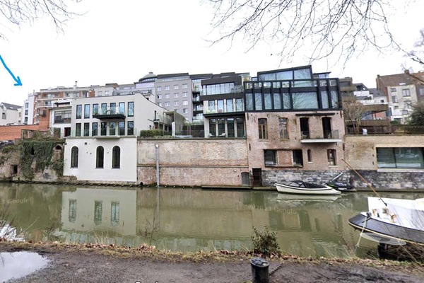 Modern riverside apartments with large windows and boat access.