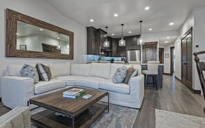 Living area - Welcome to Modern Mountain Lodge, a refined luxury townhome just minutes from Park City and Deer Valley. Set against a stunning mountain backdrop, this thoughtfully designed retreat blends modern comfort with a warm alpine aesthetic. (Kamas)