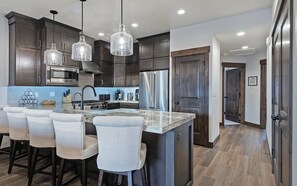 Private kitchen - Welcome to Modern Mountain Lodge, a refined luxury townhome just minutes from Park City and Deer Valley. Set against a stunning mountain backdrop, this thoughtfully designed retreat blends modern comfort with a warm alpine aesthetic. (Kamas)